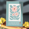 The For I Know The Plans Wall Plaque shown on a table with yellow flowers