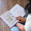 A woman reading The Way of the Wildflower