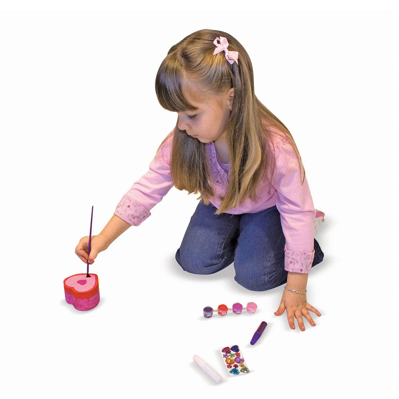 Child painting with the Wooden Heart Box Kit