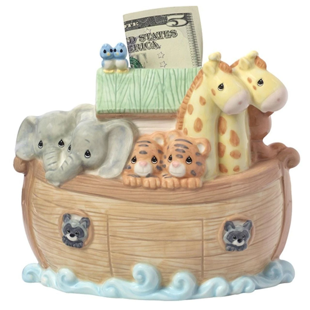 Money being put inside of the Precious Moments™ Noah’s Ark Bank