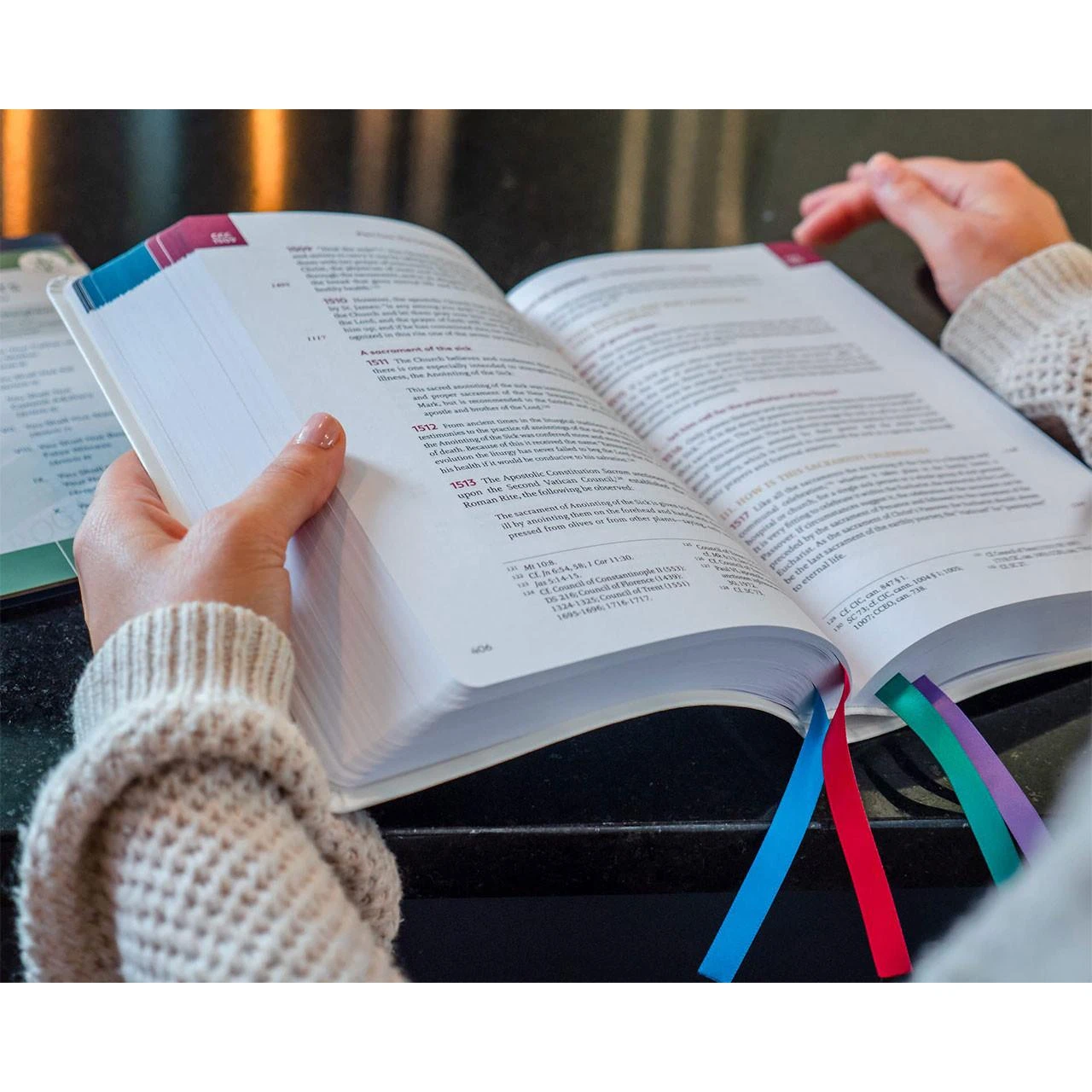 Person reading the Large Print Color Catechism of the Catholic Church