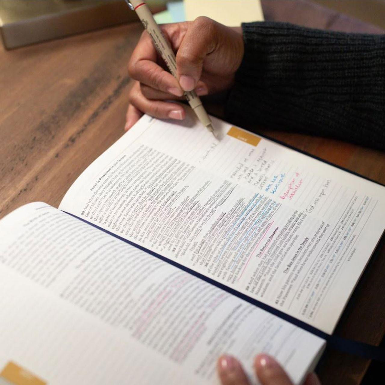 View of reader taking notes