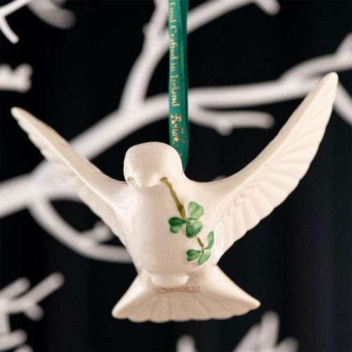 Belleek Dove Ornament shown hanging on a decorative tree