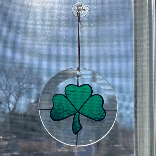 Shamrock Suncatcher shown in a window