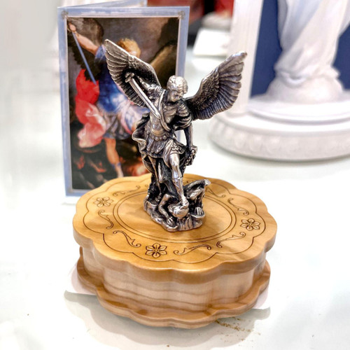 Small St. Michael Statue on top of wood case along with the mini St. Michael card