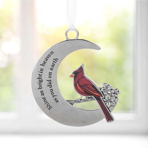 Memorial Cardinal on Moon Ornament shown in front of a window