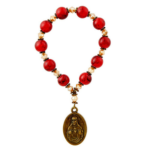 Detail of the red beads and the Sacred Heart of Jesus medal