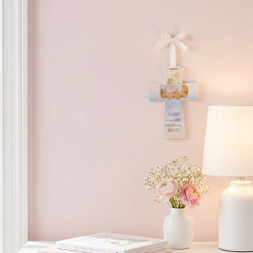 The 6IN Noah's Ark Wall Cross is shown hanging on a pink bedroom wall.