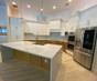 White customer-submitted kitchen with waterfall island called "Bigelow kitchen"