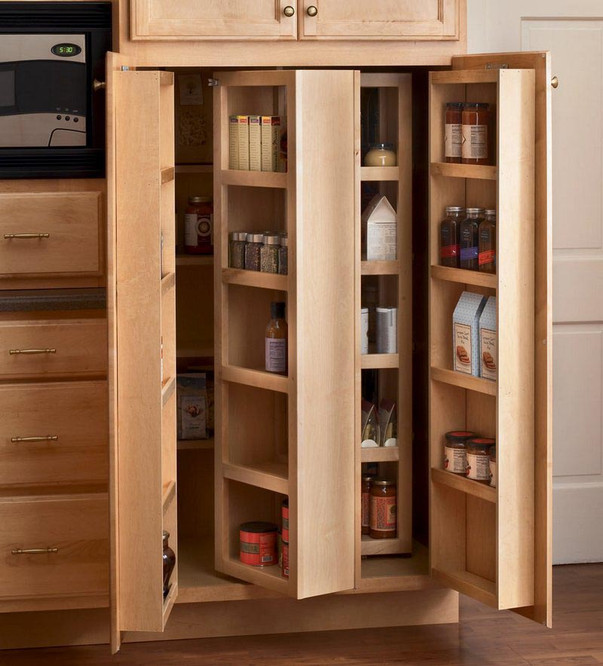 A KraftMaid 36€ -wide Multi-Storage Pantry installed in a kitchen with traditional-style doors in a Natural finish. Cabinet is open to show internal swing-out racks.