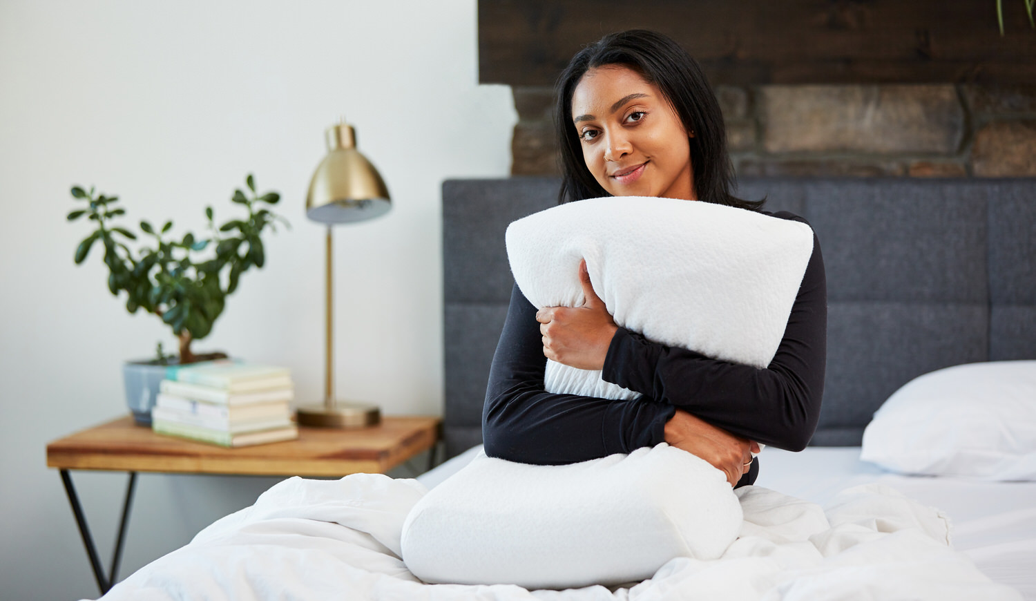Woman hugging Moonbow Adjustable Plush Memory Pillow