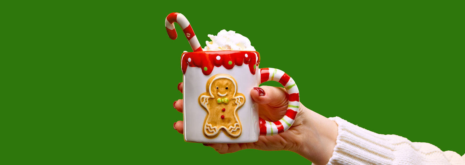 Festive holday cappuccino mug in hand