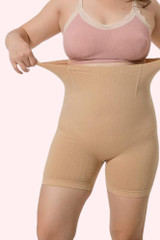 Plus size Voodoo Ultra High Waist thigh Shaper Compression in beige being stretched out at the waist