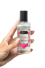 Kama Sutra Strawberry Dreams Divine Nectars Water based lubricant held by a model