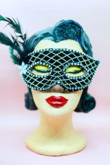 Black Velvet Half Face Venetian MasqueradeMask with feather on a vintage mannequin head front view