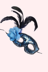 Blue Sequin Masquerade mask with flower and feather on a vintage mannequin head 