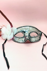 Actual product photo of Silver Sequin Masquerade mask with white flower and feather on the sidefront view