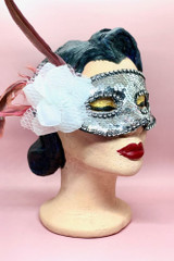 Silver Sequin Masquerade mask with white flower and feather on the side worn by a vintage mannequin head quarter side view