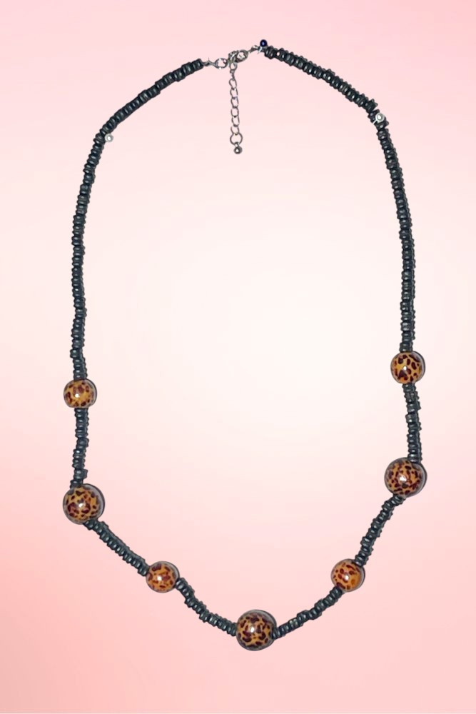 Leopard beads on balck tiki vintage necklace.