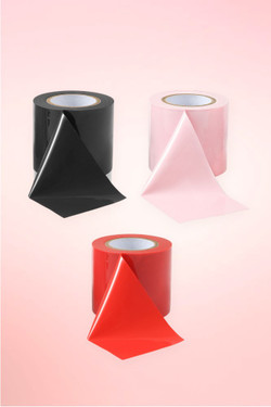 black light pink and red bondage tape rolls.