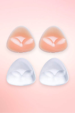 Triangle silicone bra inserts in nude and clear, two pairs shown flat on a pink background. 