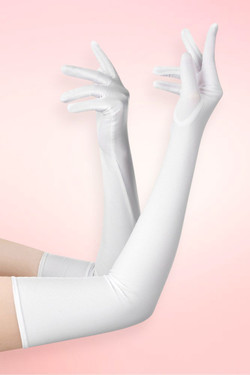 Long white spandex opera gloves in elbow length worn on both arms raised with fingers spread, against a pink background. 