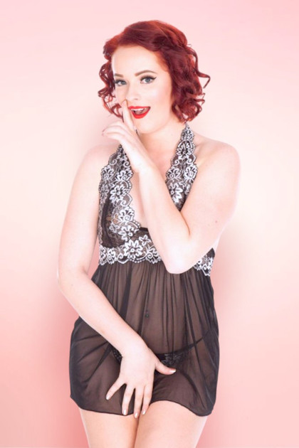 Ada black sheer mesh babydoll nightie on pin-up styled model against pink background.