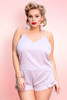 Plus Size woman wearing nude satin camisole shorts set.