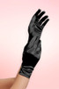 hort black satin wrist-length gloves worn on one hand, fingers spread upward, against a pink background.
