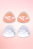 Triangle silicone bra inserts in nude and clear, two pairs shown flat on a pink background. 