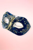 navy and gold Venetian masquerade mask angled right on pink background.