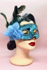 Blue Sequin Masquerade mask with flower and feather on a vintage mannequin head