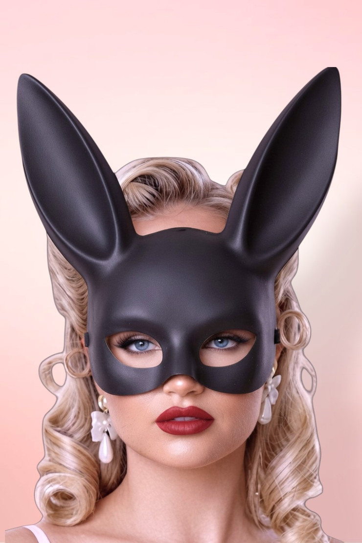 Three-quarter profile of a woman in a matte black bunny masquerade mask.
