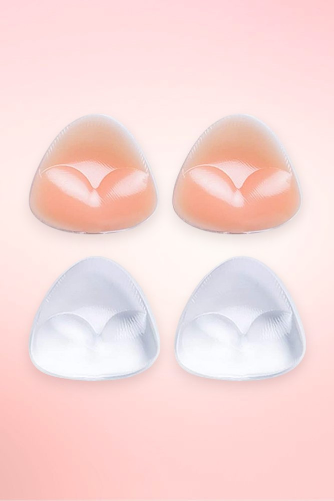 Triangle silicone bra inserts in nude and clear, two pairs shown flat on a pink background. 