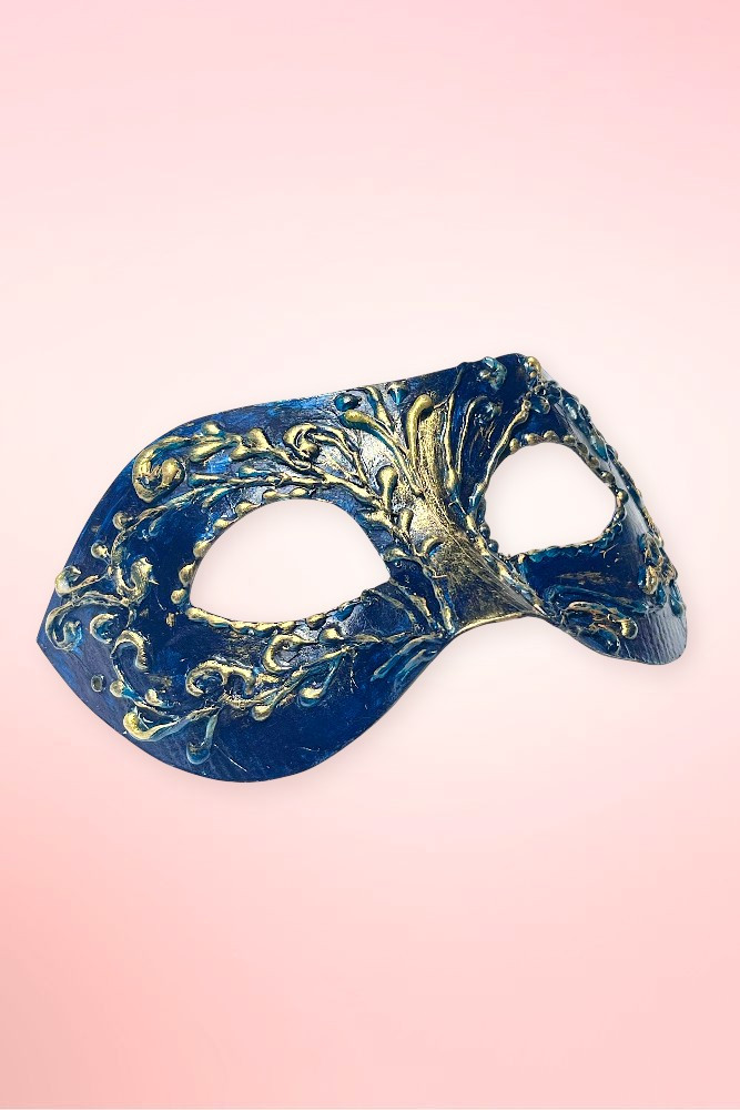 navy and gold Venetian masquerade mask angled left on pink background. 