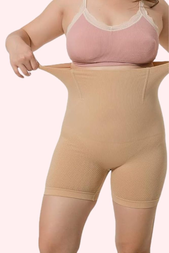 Plus size Voodoo Ultra High Waist thigh Shaper Compression in beige being stretched out at the waist