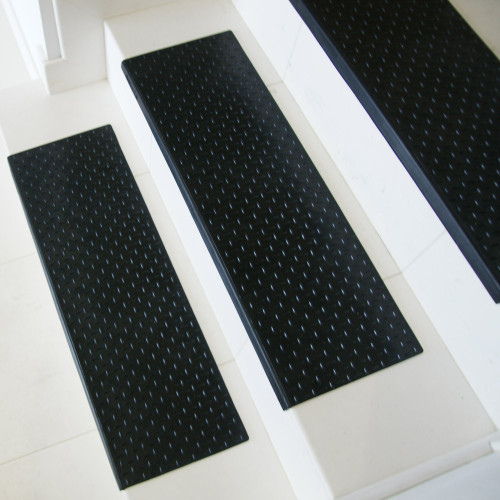 Side view of white stairs featuring Diamond-Plate Rubber Stair Mats