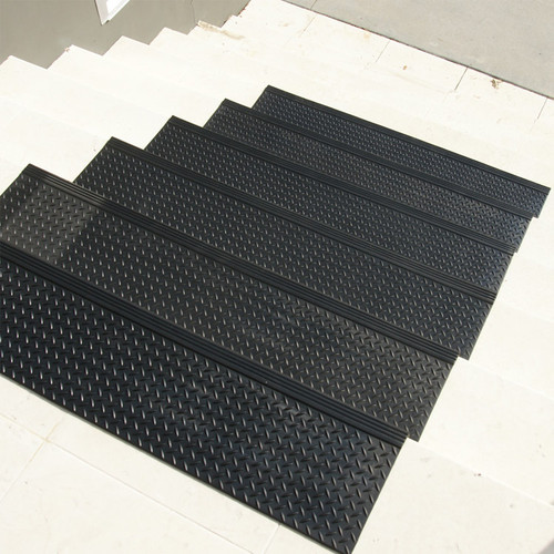 Descending stairs featuring Diamond-Plate Commercial Stair Treads