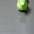 Distant Green horse toy on dark gray block grip flooring