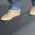 Person wearing light brown shoes on Comfort Cloud Foam Mat