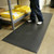 Person beside shelving, standing on Foot Rest Anti-Fatigue Mats