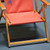 Red folding canvas-seat chair on gray S-Grip Drainage Mat