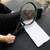 Person with tennis racket sitting on towel, on Shark Tooth Mat