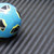 A Blue and black Soccer ball  on Fishbone-Pattern Rubber Flooring