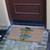 angle view of Need Directions? You Are Here Doormat at door