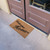 angle view of "Simple and Loving" - Welcome Home Doormat at double doors