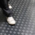 A person stepping on Black-Diamond Grip PVC Floor
