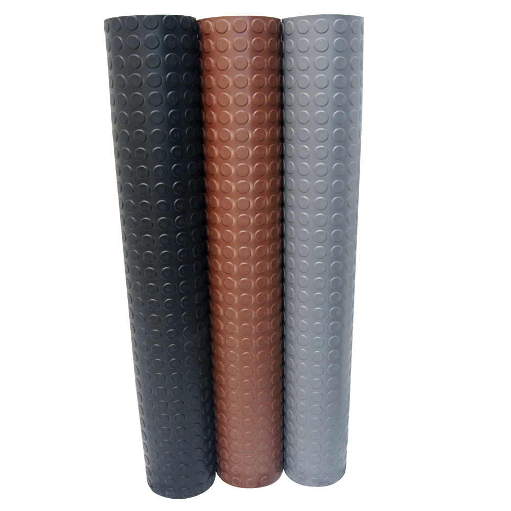 Three standing Goodyear Coin-top rolls, one black, one chocolate brown, and one dark gray