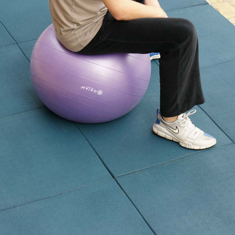 Blue Eco Sport Interlocking Rubber Flooring Tiles under person sitting on yoga ball