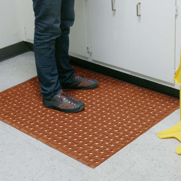 Person standing on Red Paw Grip Runner Mat by the warning sign 